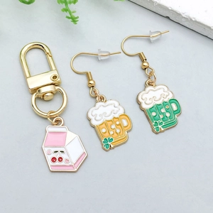 Detailed view of colorful enamel milk carton and beer mug pendants for DIY jewelry