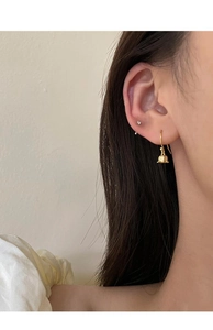 Detailed side view of gold lily of the valley drop earrings worn for elegant summer style