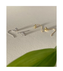 Close-up of gold and silver lily of the valley flower drop earrings with leaf accents