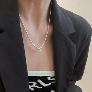 Close-up of minimalist S925 silver snake chain with unique fish hook clasp on model