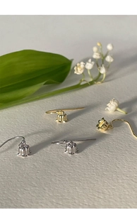 Detailed view of lily of the valley earrings in silver and gold flower bud design