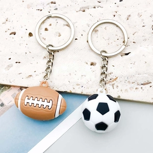 Detailed macro of PVC sports ball pendants for DIY jewelry with silver keyrings