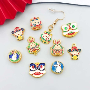 Detailed view of colorful enamel Chinese New Year charms including God of Wealth and lion dance