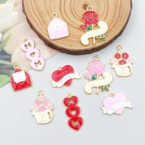 Macro shot of pink enamel heart and carnation charms for Mother's Day jewelry DIY