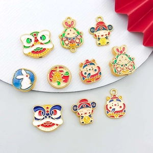 Detailed macro view of assorted Chinese fortune god and lion enamel DIY pendant charms