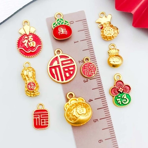 Traditional Chinese alloy charms with red enamel lucky pouches and ruler for size