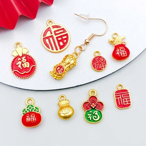 Detailed view of red and gold Chinese New Year Ruyi lucky bag charms for DIY jewelry making