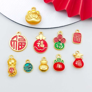 Macro view of red enamel gold lucky bag and ruyi charms for DIY jewelry making