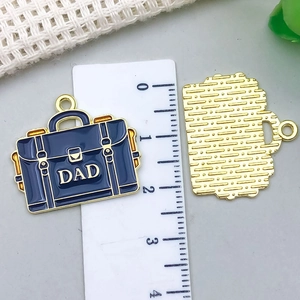 Detail view of gold-plated briefcase pendant with blue enamel and DAD lettering