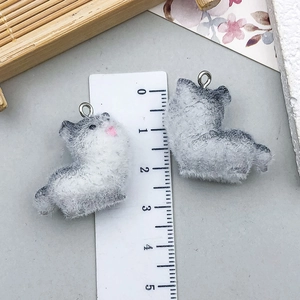 Detail of grey and white flocked cat charms with silver jump rings and scale measurement