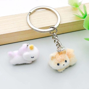 Close-up of colorful flocked resin unicorn and puppy charms for jewelry making
