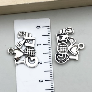 Detailed macro view of vintage zinc alloy golf pendant with GOLF text and heart design