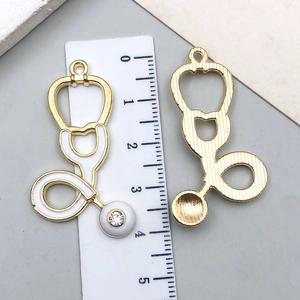 Detail view of a 40mm stethoscope charm with white enamel and sparkling crystal