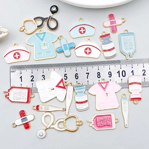 Assorted colorful enamel medical charms including stethoscope and nurse hat with ruler
