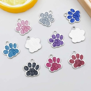Macro detail of colorful glitter cat paw charms with sparkling enamel finish for DIY jewelry