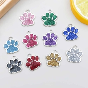 Detailed view of colorful paw-shaped alloy pendants with glitter resin for DIY jewelry