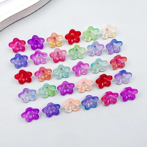 Flat lay of colorful matte acrylic lily of the valley flower beads for DIY jewelry making
