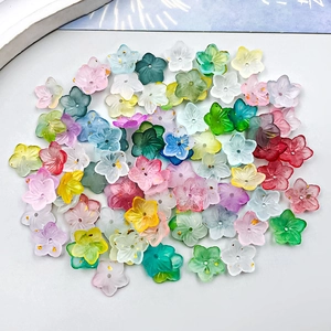 Macro shot of colorful acrylic sakura flower beads with gold foil inside for DIY jewelry