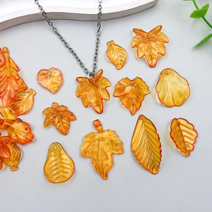 Detailed view of amber translucent resin leaf pendants for DIY necklace jewelry making