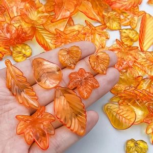 Mix of orange translucent acrylic leaf pendants for DIY jewelry making and necklaces