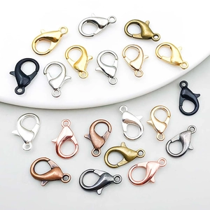 Various colored alloy lobster clasps for DIY jewelry making on a white ceramic tray