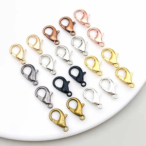 Macro view of assorted metal lobster clasps in gold silver and bronze for DIY jewelry