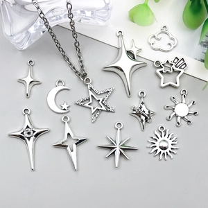 Detail of silver alloy celestial charms including moon and star pendants for DIY jewelry