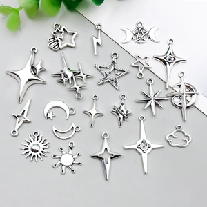 Detailed view of silver alloy moon and star pendants for DIY jewelry making