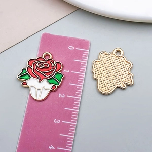Detailed macro view showing red rose enamel pendant dimensions and golden textured back