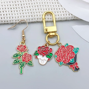 Detail of red rose pendants with enamel drip finish for DIY bracelets and necklaces