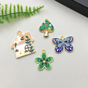 Detailed macro view of colorful enamel mushroom house butterfly flower alloy pendants