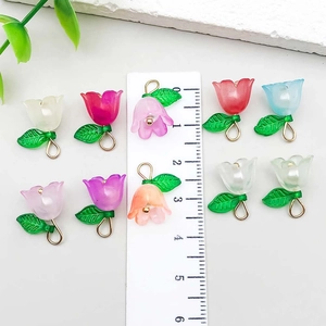Colorful acrylic lily of the valley flower pendants with ruler for size reference