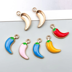 Macro detail of colorful enamel chili charms showing front and back alloy textures