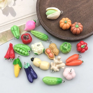 Detailed overhead shot of assorted resin vegetable pendants for DIY jewelry making