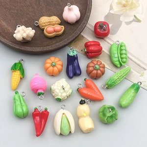 Macro view of assorted resin vegetable charms with metal loops for DIY jewelry making