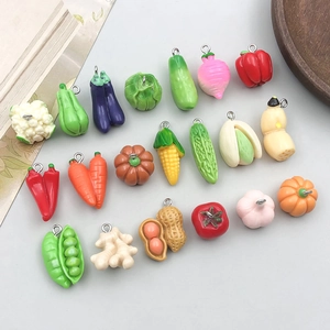 Flat lay of detailed colorful resin vegetable charms with metal loops for DIY jewelry