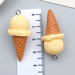 Detail shot of resin cartoon ice cream cone charms with scale ruler showing 4cm height
