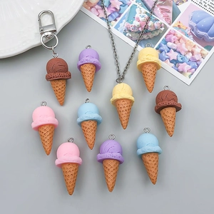 Close-up of colorful resin ice cream cone charms in assorted macaron colors for DIY jewelry