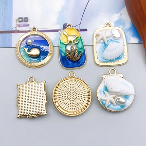 Detail of colorful marine alloy pendants featuring whale, starfish and enamel textures