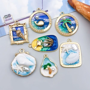 Mixed set of seven ocean-themed enamel alloy charms with pearls and golden finish