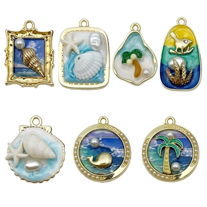 Set of seven gold alloy ocean charms with blue enamel and pearls for DIY jewelry making