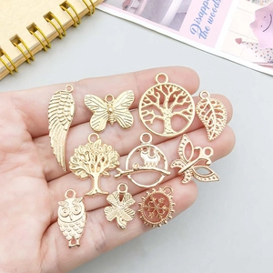 Set of 10 gold alloy charms featuring butterfly, owl, and tree of life motifs for DIY jewelry