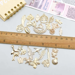 Mix of 30 gold alloy charms featuring owl, feather, and dolphin for DIY jewelry making