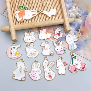 Detailed view of assorted white enamel bunny rabbit charms for DIY jewelry making