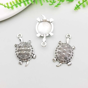 Detail of silver alloy turtle pendants for DIY jewelry making with shell pattern