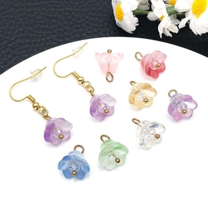 Close-up of lily of the valley resin flower charms for DIY jewelry in pastel colors