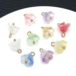 Detailed view of colorful lily of the valley glass beads with gold hanging loops for DIY jewelry