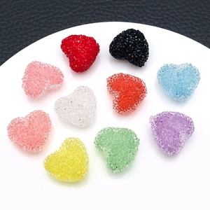 Macro detail of colorful frosted acrylic heart charms with sugary texture for DIY jewelry