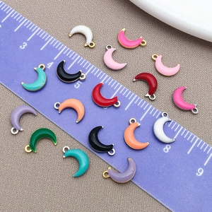 Colorful enamel moon pendants in stainless steel with measurement scale reference