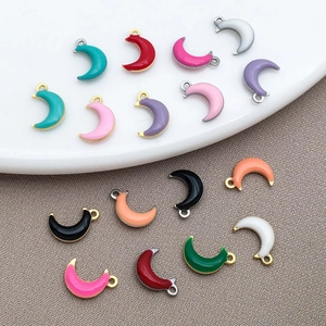 Detailed view of assorted colorful enamel moon pendants for DIY jewelry making
